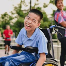 Boy in a wheelchair laughing