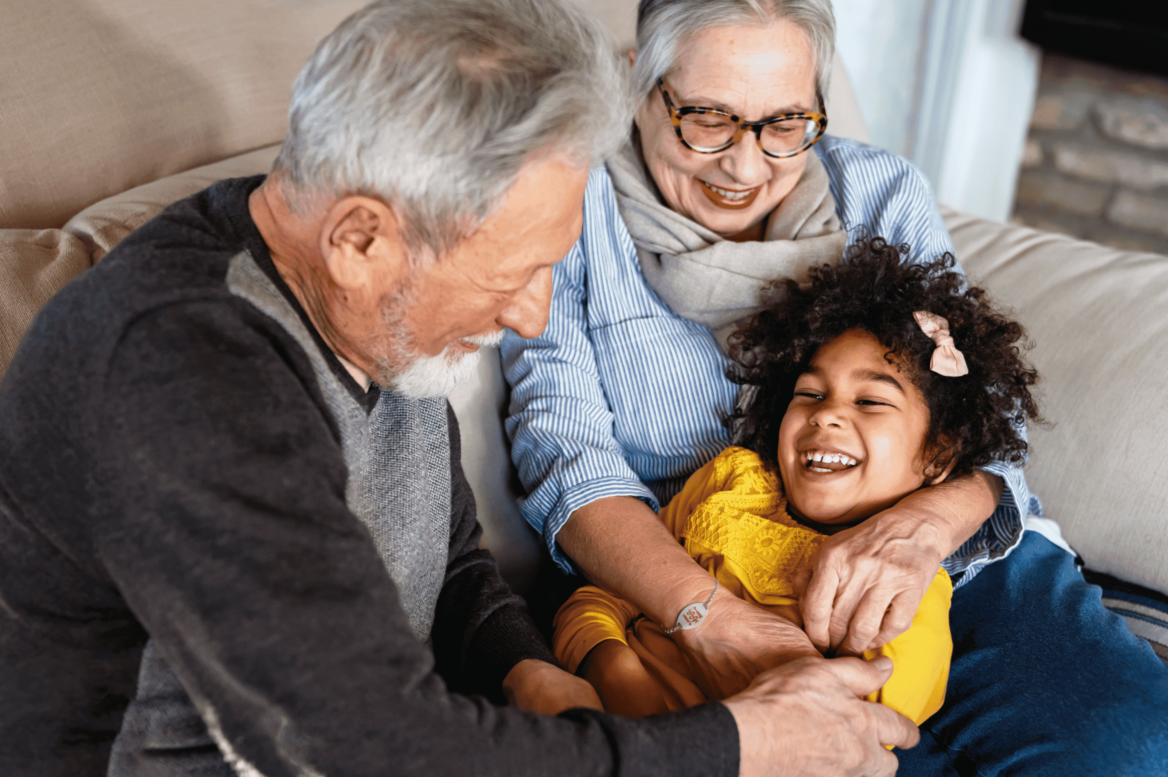Grandfather and grandmother wearing her medical ID bracelet playing with their granddaughter