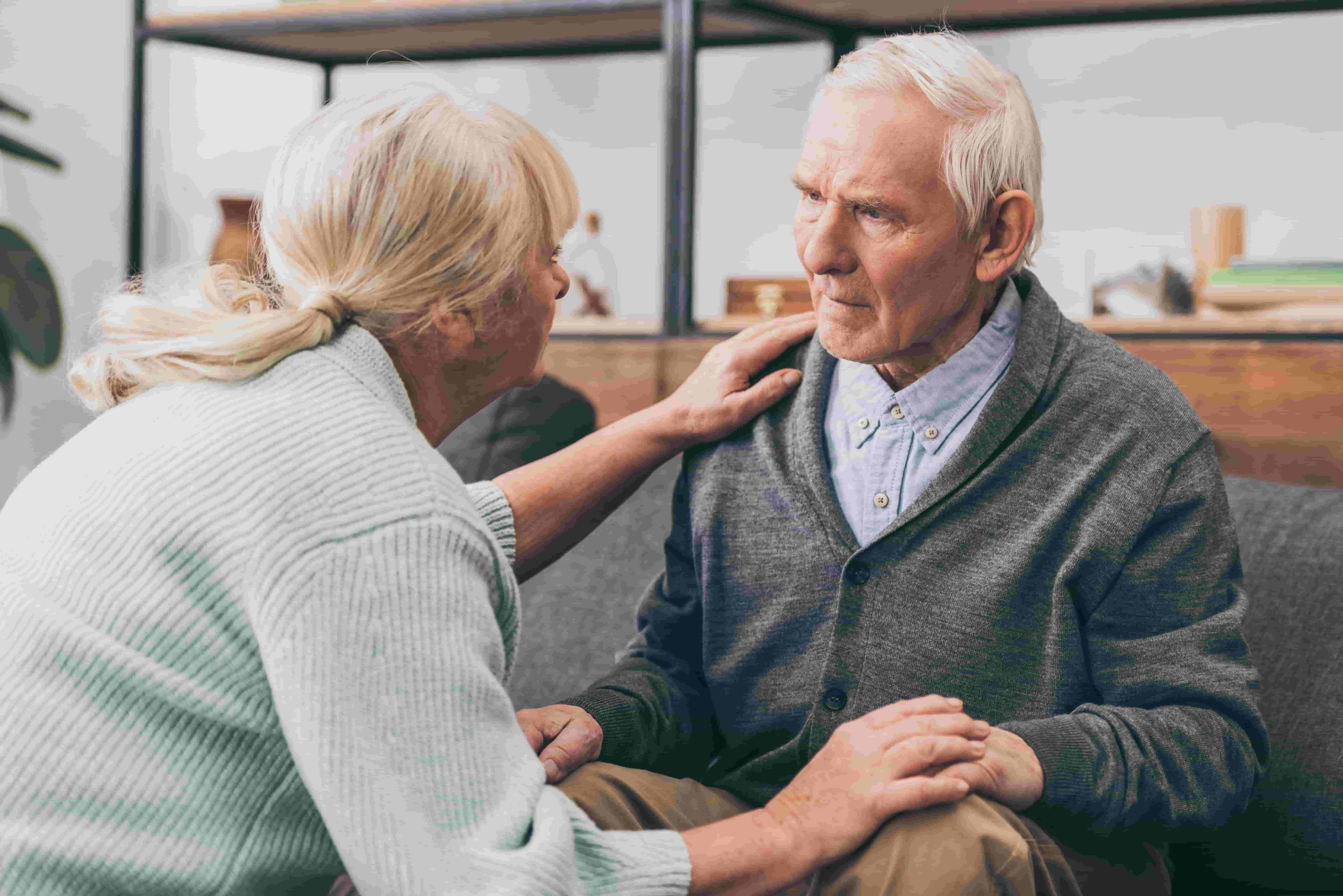 Older woman comforts older man with dementia
