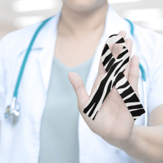 Doctor showing a ribbon on her hand to show awareness for Ehlers Danlos