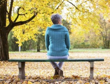 Older woman sitting on a park bench