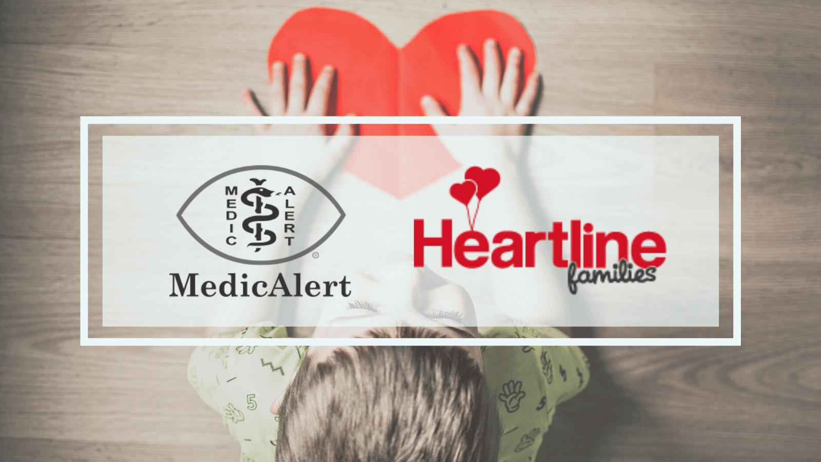 Heartline families banner with a child holding a heart shaped red piece of paper