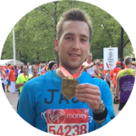 Our member Jack Cooke when he finished a marathon, holding his medal: MedicAlert for Anaesthetic Allergy