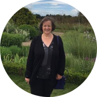 Our member Linda Alcock smiling at a garden: MedicAlert for TINU, VP shunt, Connective Tissue Disease, Chiari 1 & CKD